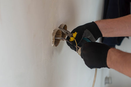 one electrician installs the light in the apartment where the repair