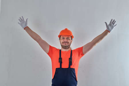 a builder in white gloves raised his hands upの写真素材