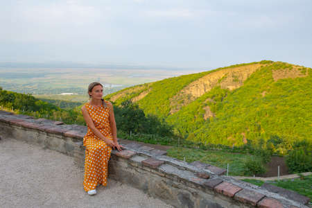a girl sits on the parapet of a monastery in sighnaghiの写真素材