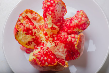 beautiful red pomegranate lies on a plate