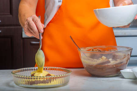 the dough without cocoa is laid out in a moldの写真素材