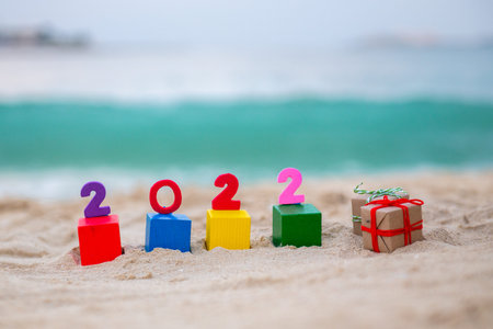 cubes with the numbers of the new year 2022 lie on the sand