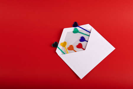 hearts in a white envelope on a red backgroundの写真素材