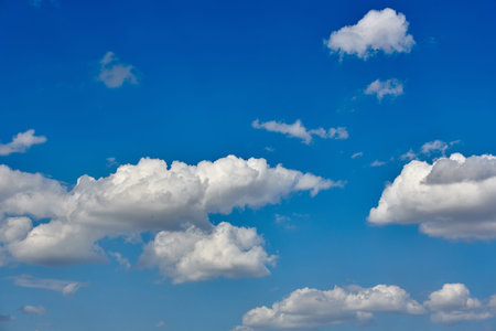 big whites float across the blue sky