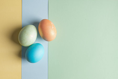 several Easter eggs lie on three colored backgrounds