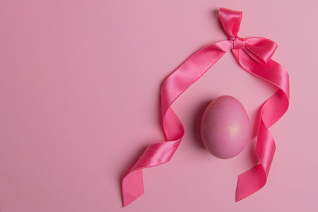 bow and easter pink egg on pink background