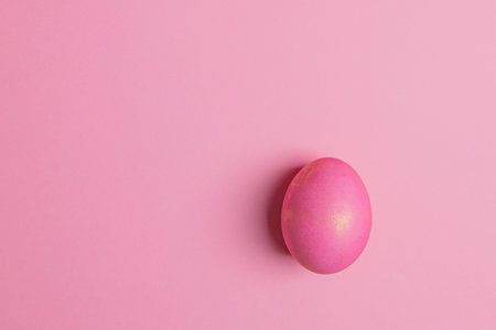 one easter pink egg on a pink backgroundの写真素材