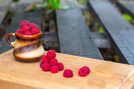 raspberries in a glass lie on a tray