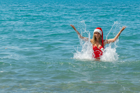 Christmas by the Sea: Red Swimsuit and Santa Hat Comboの写真素材