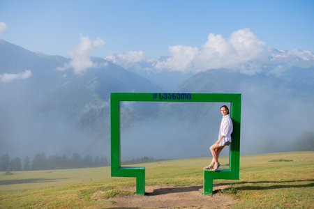 Girl Standing in Photo Frame in Ushguli Mountainsの写真素材
