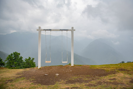 Two swings stand in the mountains of Georgiaの写真素材