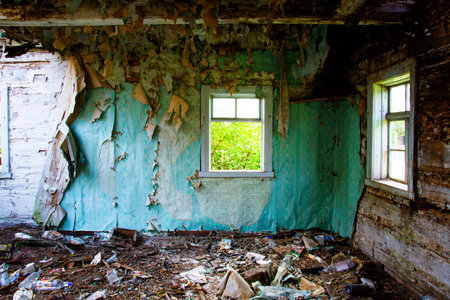 the wall of the collapsed house after the earthquake, a light window against the gray walls. old...