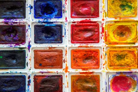 Palette with used watercolors paintbox. Paintings art concept. Painting hobby. Back to school. Top view. Copy space.の写真素材