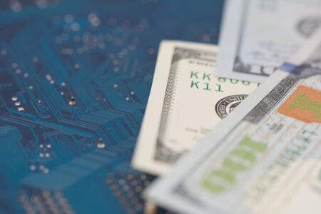 Business money dollar on PCB circuit board technology. Business concept of world digital money and remote job. Selective focusの写真素材