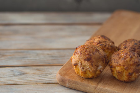 Fresh pastry. Homemade muffins on white wooden table background