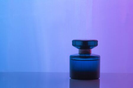 Aftershave, cologne, perfume bottle set on dark purple background with reflection. Women's perfumeの写真素材