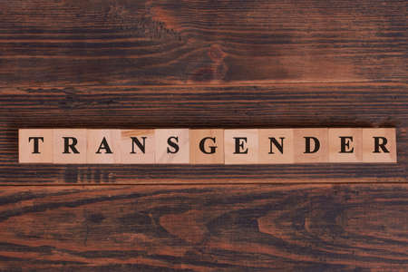 Transgender word lettering made of wooden cubes concept on dark rustic wooden background. Human rights movementの写真素材