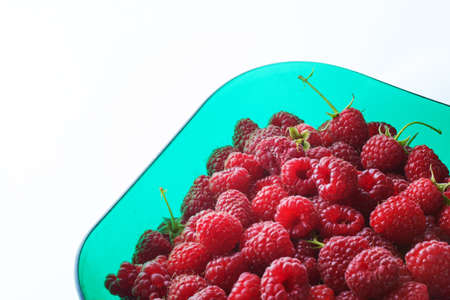 Ripe Delicious raspberries in green bowl. Healthy food organic concept. Selective soft focusの写真素材