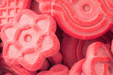 Pink cookie with sugar background. Close-up view