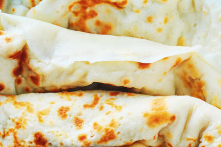 Fried pancakes roll background. Homemade pancakes with cottage cheese for breakfast. Concept of Russian cuisineの写真素材