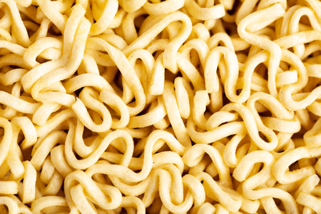 Raw instant noodles yellow texture or background. Closeup view