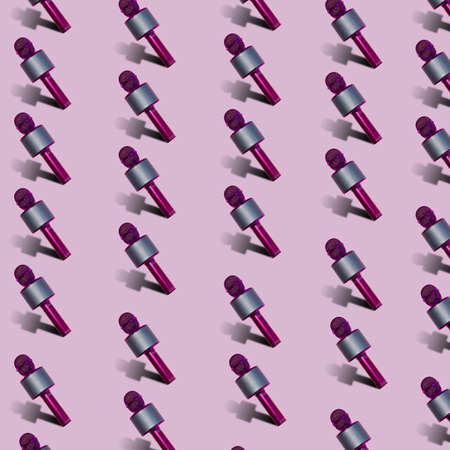Pattern made with microphones on pink background. Minimal sound conceptの写真素材