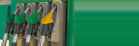 Panoramic banner Pump nozzles at the gas fuel station. Gasoline dispenser on petrol station. Guns...