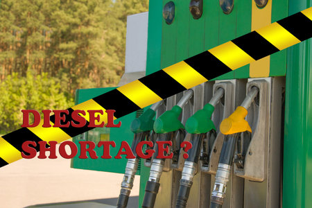 Gas station closed. Petrol pump not working. Black and yellow line of barrier tape forbids passage....