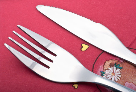 Fork and knife on a red napkin