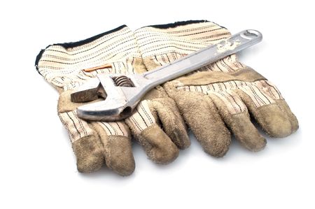 Dirty leather gloves and monkey wrench,isolated on whiteの写真素材