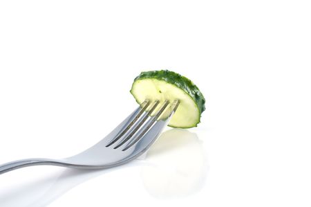 Piece of cucumber on the fork の写真素材