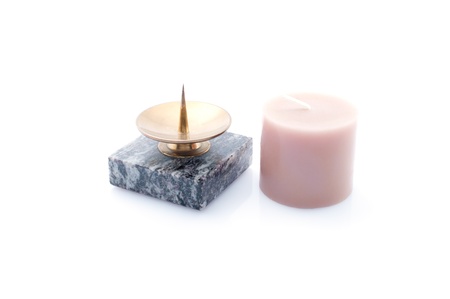 Candlestick made of stone and candle  isolated on whiteの写真素材