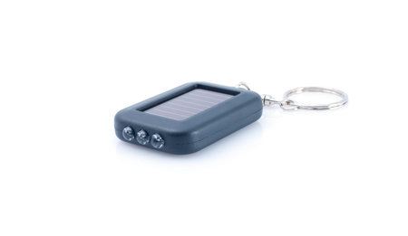 Black mini flashlight on solar batteries on white background