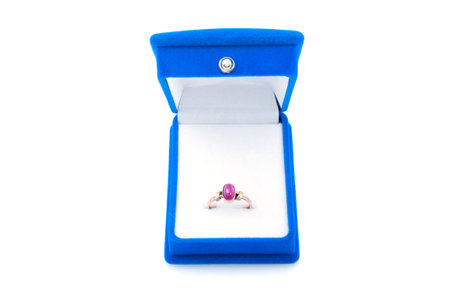 Gold ring with ruby in blue velvet jewelry box , isolated on white background