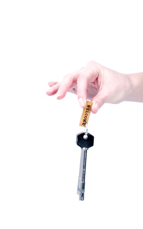 Key from a new house in the hand of womanの写真素材