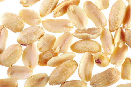 Close up of fried salted peanuts on white background