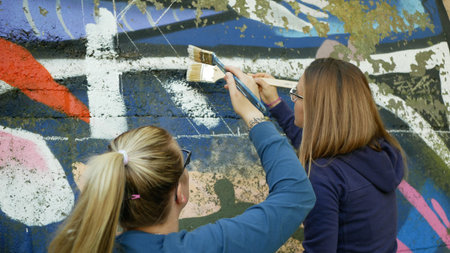OLOMOUC, CZECH REPUBLIC, SEPTEMBER 22, 2019: Activist people paints and repainting symbol Extinction...