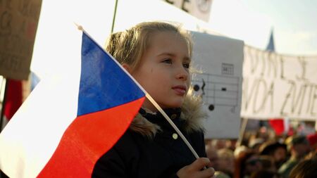 PRAGUE, CZECH REPUBLIC, NOVEMBER 16, 2019: Demonstration of people crowd against Andrej Babis demise, 300,000 mass protesters crowd throng of activists Letna Prague, flags young girlのeditorial素材