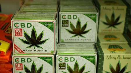 PRAGUE, CZECH REPUBLIC, SEPTEMBER 9, 2019: Cannabis cookies shop store Prague, hash muffin strong, packaged hemp cannabidiol CBD biscuit or cracker seeds and in relieves pain, leaf symbol greenのeditorial素材