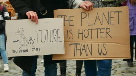 OLOMOUC, CZECH REPUBLIC, NOVEMBER 30, 2019: Friday for future, demonstration against climate change, banner sign the planet is hotter than us and money polilician gases, activists and activismのeditorial素材