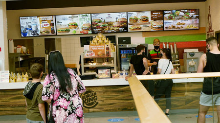 PRAGUE, CZECH REPUBLIC, JUNE 22, 2020: Coronavirus mask face hamburger burger king fast food...