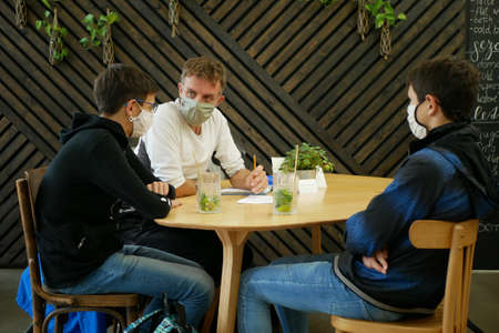 PRAGUE, CZECH REPUBLIC, JULY 22, 2020: Coronavirus mask face family coffe house restaurant food snacks bar children man shopping center supermarket, people covid-19, wearing outbreak respiratoryのeditorial素材