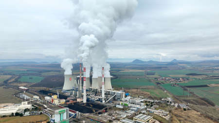 MOST, CZECH REPUBLIC, NOVEMBER 15, 2020: Coal brown power plant factory fired station Pocerady, chimney smokes stacks smoke emission, smokestacks air pollution airborne dust, heating chemicalのeditorial素材