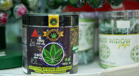 PRAGUE, CZECH REPUBLIC, SEPTEMBER 25, 2021: Cannabis cookies shop sativa weed store Prague, packaged hemp cannabidiol CBD biscuit food cracker seeds dark in relieves pain, leaf symbolのeditorial素材