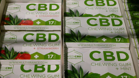 PRAGUE, CZECH REPUBLIC, SEPTEMBER 25, 2021: Cannabis chewing gum bubble strawberry medical CBD chew sweetness candy sweet shop store packaged hemp cannabidiol seeds leaf symbol, shelf sugarのeditorial素材