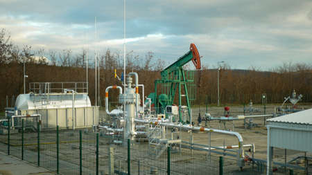 DAMBORICE, CZECH REPUBLIC, NOVEMBER 15, 2021: Pumpjack oil fracking crude extraction pump jack machine field, fossil fuel energy industry pumping unit equipment, refinery drilling mechanical machineryのeditorial素材