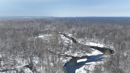 River winter snow delta floodplain meander drone aerial inland video shot in sandy sand alluvium freezing cold frost, benches forest and lowlands wetland swamp, quadcopter view flying fly flight showの写真素材