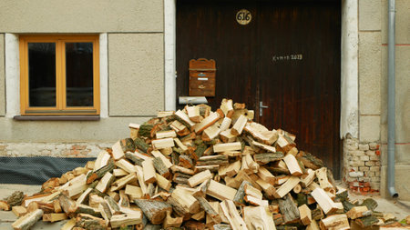 Firewood chopped logs stacked pile wood poplar storage for heating house, wood vintage attribute forest barbecue country house large oak addition lumbers piled up small wooden, energy crisis, Europeの写真素材