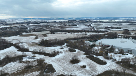 Meadow drone aerial winter landscape snow floodplain frost Plane loucky fog morning over nature snowy reserve, Litovelske Pomoravi icy protected landscape area, pond ice plants, willows, field Europeの写真素材