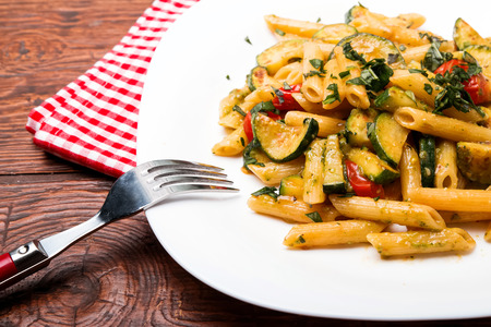 Delicious pasta with sauce,zucchini and tomatoesの写真素材